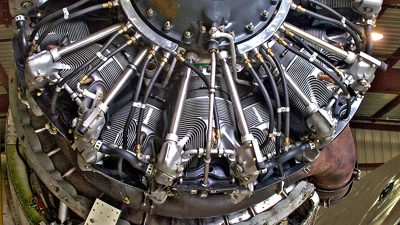 Close view of aircraft engine components and hoses