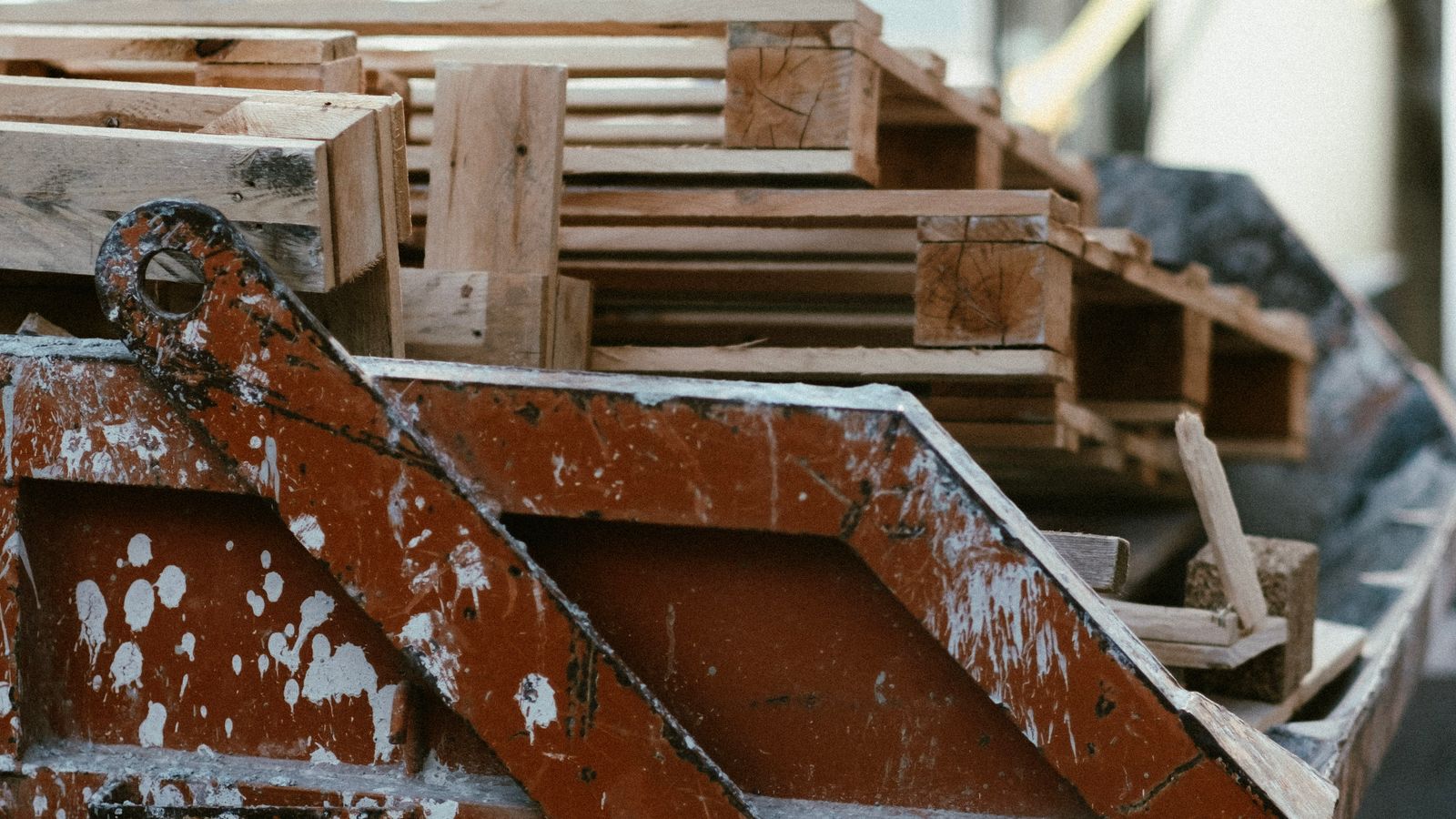 Construction debris and wood pallets staged in a waste container